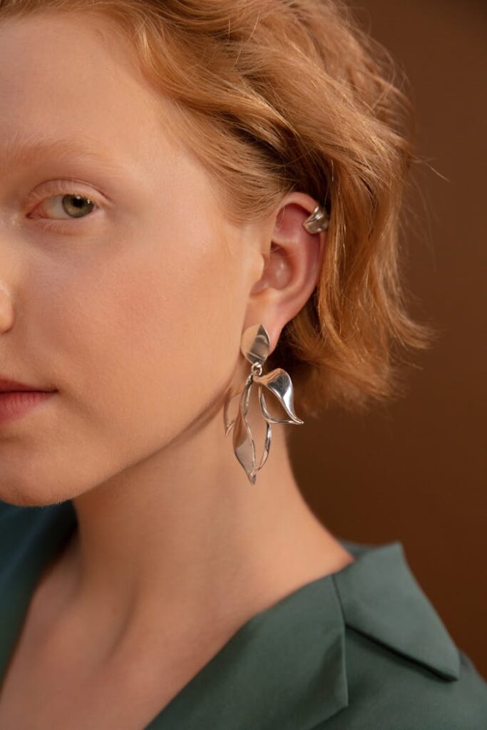 Woman in Silver Earrings and Gray Shirt